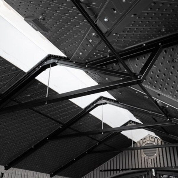 Close-up interior view of the Lifetime storage shed's steel A-frame trusses and ridge skylight panels.