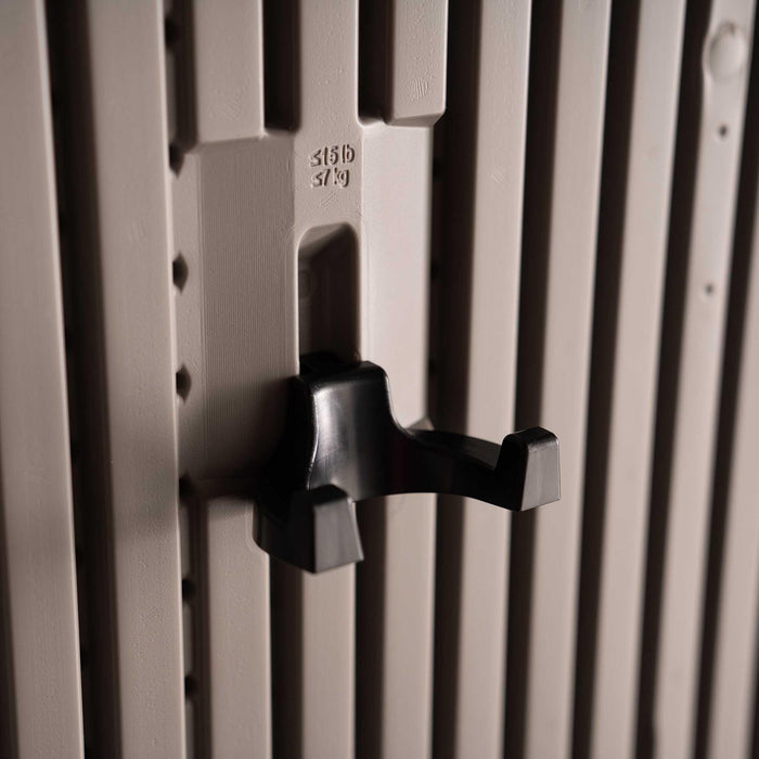 Close-up of a black double-prong wall hook rated 15 lb / 7 kg mounted on the slotted interior wall panel of the Lifetime Farmhouse Storage Shed 60542