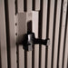 Close-up of a black double-prong wall hook rated 15 lb / 7 kg mounted on the slotted interior wall panel of the Lifetime Farmhouse Storage Shed 60542
