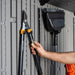 Close-up of the Lifetime storage shed's interior wall hooks holding pruning shears and a broom.