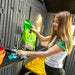 Woman organizing garden supplies on the Lifetime storage shed's interior potting table.