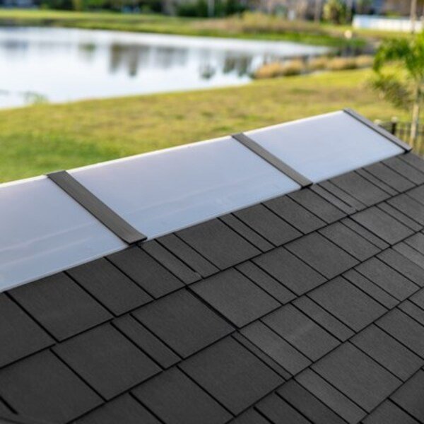 Close-up of the Lifetime storage shed's full-length ridge skylight panel with a lake and yard in the background.