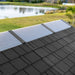 Close-up of the Lifetime storage shed's full-length ridge skylight panel with a lake and yard in the background.
