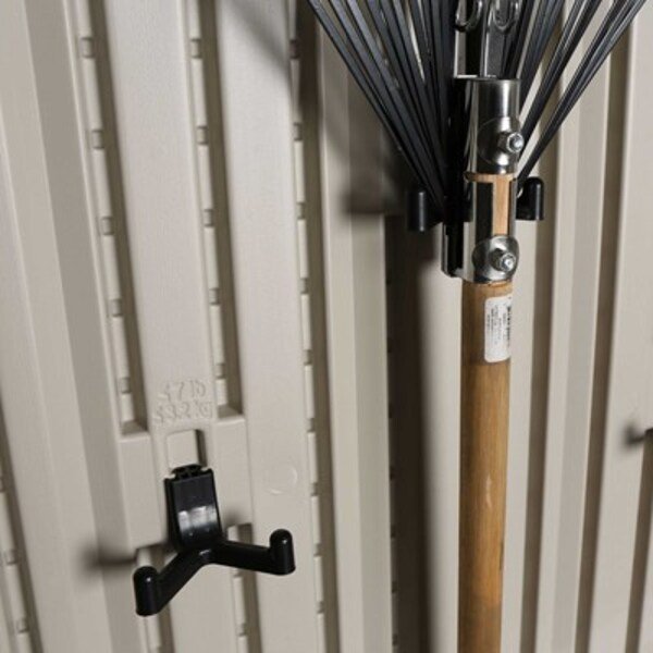 Close-up of a rake mounted on the Lifetime storage shed's interior wall hook.