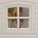 Close-up of the Lifetime storage shed's window showing the interior pegboard and tools through the glass.