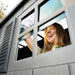 Close-up of a woman opening the Lifetime storage shed's window with decorative shutters.