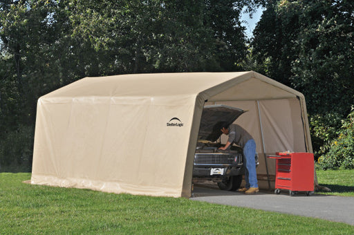 A man working on his car under the shade provided by the ShelterLogic Autoshelter 10x20