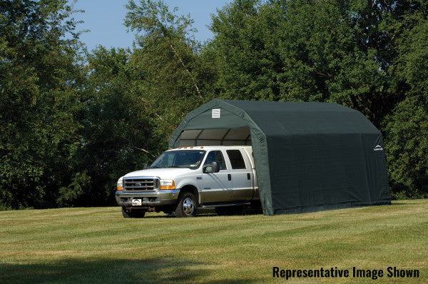 Green ShelterLogic Sheltercoat with gambrel roof, providing shade for a parked RV. This portable carport protects vehicles from sun, rain, hail, and other weather elements.