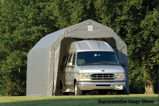 ShelterLogic detached garage with a gray roof storing a large RV. This portable garage has a steel frame and fabric cover, providing protection for oversized vehicles.