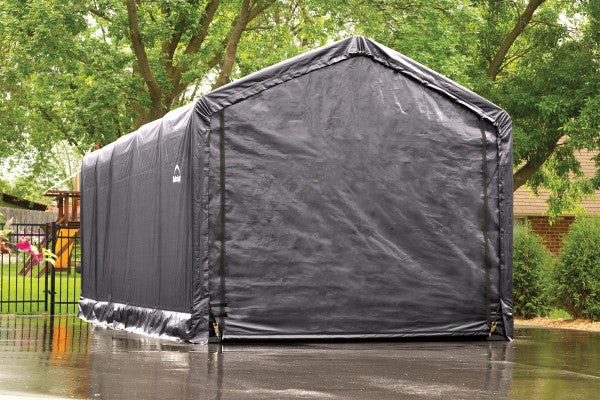 Front view of a gray ShelterLogic ShelterTube Garage with a closed cover featuring a zipper door. Its sturdy square tube steel frame provides protection for vehicles, equipment, and other outdoor storage.