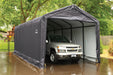 White pickup truck parked under a ShelterLogic ShelterTube garage on a wet cement pad. Trees are visible in the background. This weatherproof garage protects vehicles from rain, snow, and sun damage.