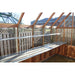  Interior view of the Alton Lancing Greenhouse showcasing metal shelves and wooden supports.