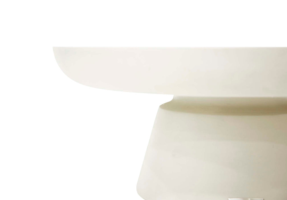 Side profile of Elementi Kylix Series small coffee table in cream white, showcasing its round top and solid base.