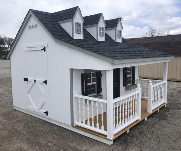 Side view angle of the Pennfield Cottage Playhouse by Little Cottage Company, featuring its charming white and black paint scheme.