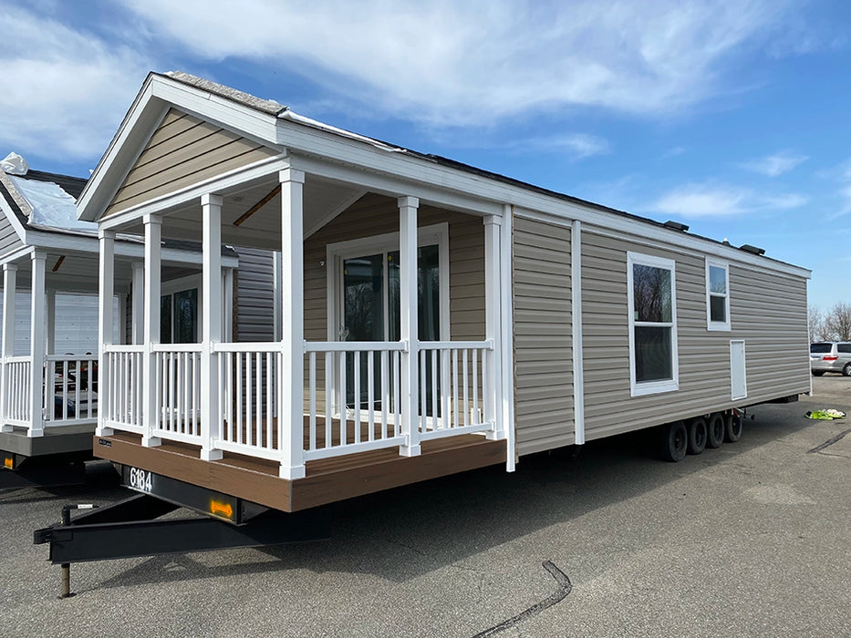 Side view of the Champion Home without Loft by Oasis Tiny Estates, displaying the length and its multiple windows of the tiny home.