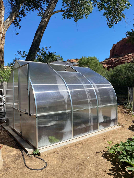 Side view of Exaco Hoklartherm Riga Greenhouse 3, highlighting roof vent, aluminum frame, and clear polycarbonate panels for year-round gardening.