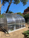 Side view of Exaco Hoklartherm Riga Greenhouse 3, highlighting roof vent, aluminum frame, and clear polycarbonate panels for year-round gardening.