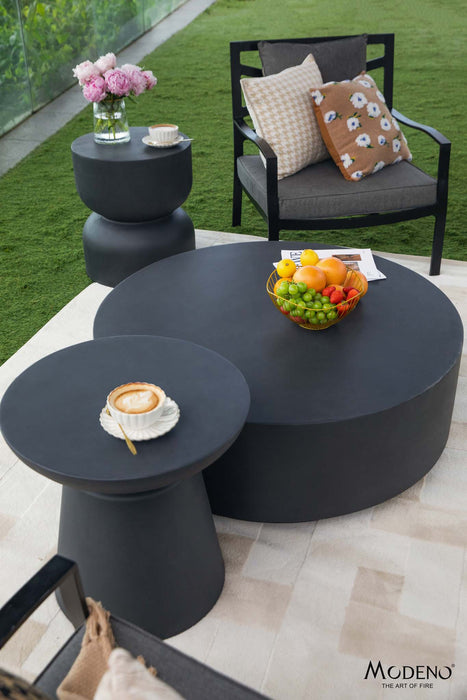 Outdoor setup featuring the Kylix series slate black side table, complemented by other tables and seating elements for a cozy atmosphere.