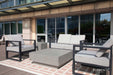 A sleek and modern balcony setup with the Elementi Tevere Series Square Coffee Table in Space Grey, accompanied by contemporary seating on a geometric rug.