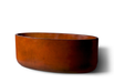 Slick Rock Bell Linear 60 in. concrete planter trough in rust orange stain, side view