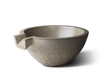 A Slick Rock Concrete Spill Water Bowl Classic, a gray concrete bowl with a rounded shape and a spout-like cutout on one side.