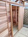 Close-up of the sliding door of the Alton Cedar Fusion Greenhouse, highlighting the wooden panels and metal track.