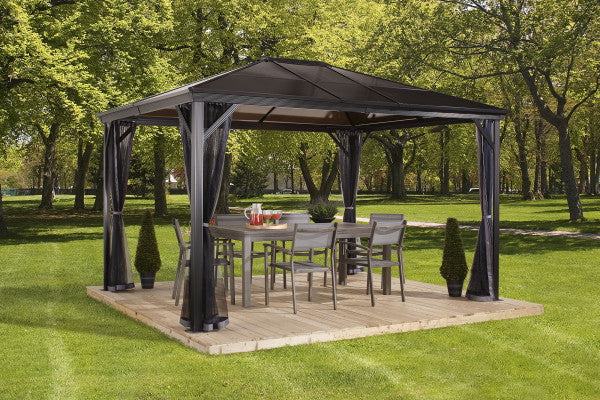 Elegant outdoor dining under Sojag Verona Gazebo 10x12 ft with chairs and table set up on a wooden deck.