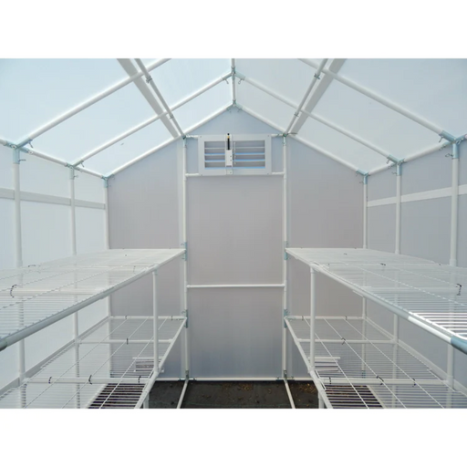 Interior view of Solexx Garden Master greenhouse showcasing the white metal frame and clear paneling with spacious wire shelving units.