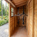Side angle view of the SpaceSaver 12x4 lean-to shed with wooden sliding doors and a sloped roof.