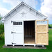 Front view of Little Cottage Co. Star Barn with one door open revealing wood interior, star vent detail, and white exterior siding.