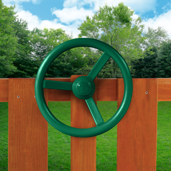 The green steering wheel of the	outdoor Chateau Tower Swing Set