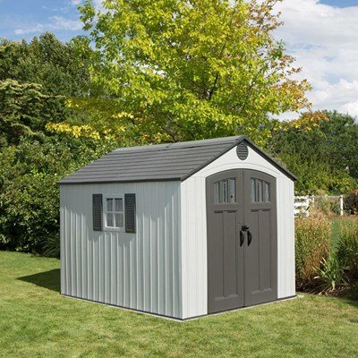 Lifetime 8x10 ft. storage shed in a backyard with tree backdrop, front angle view with closed doors.