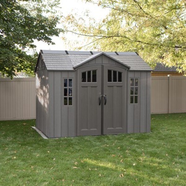 Lifetime 10x8 ft. side entry storage shed in a backyard with tree shadow, front angle, closed doors.