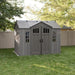 Lifetime 10x8 ft. side entry storage shed in a backyard with tree shadow, front angle, closed doors.