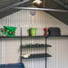 Interior view of the Lifetime 8x15 ft. storage shed showing the roof truss and shelving with tools.