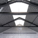 Interior view of the Lifetime side entry storage shed looking up at the roof trusses and skylight panels.