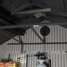 Interior view of the Lifetime 8x5 ft. storage shed looking up at the roof truss and skylight, with stored items below.