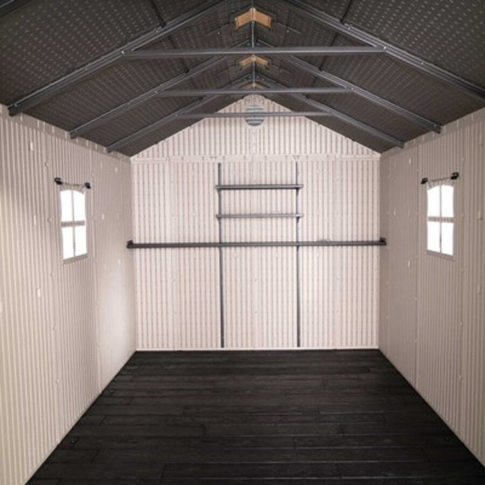 Interior view of the Lifetime 8x12.5 ft. storage shed showing the roof truss, side windows, and shelving rail.