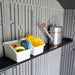 Close-up of the Lifetime storage shed's interior shelf holding storage bins and a watering can.
