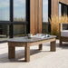 Stratton 55 coffee table outdoor patio lifestyle with Stratton lounge chairs
