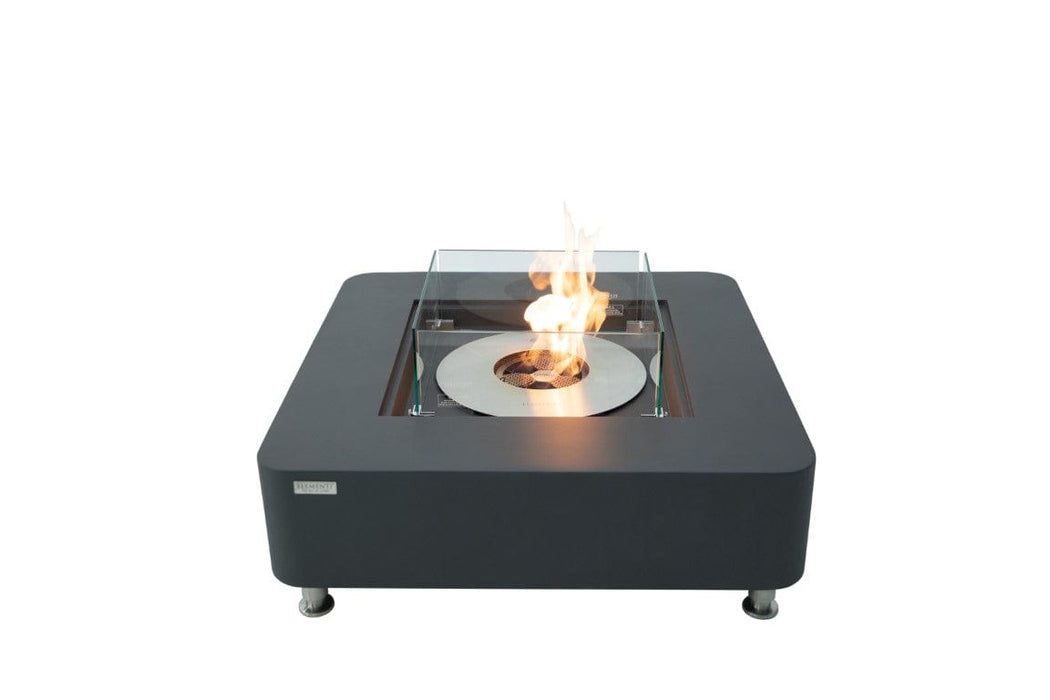 Isolated studio shot of the Elementi Perth Fire Table in slate black with flame lit and wind guard