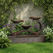 Tiered water fountain, Exaco Infinity in Rust finish, surrounded by ivy, purple flowers, and green lawn.