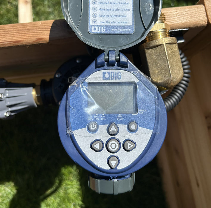 Timer setup of the Outdoor Living Today (OLT) Auto-Watering Kit with control buttons visible.