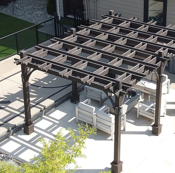 An overhead view of the Outdoor Living Today Pergola with Retractable Canopy in dark brown with outdoor seating underneath