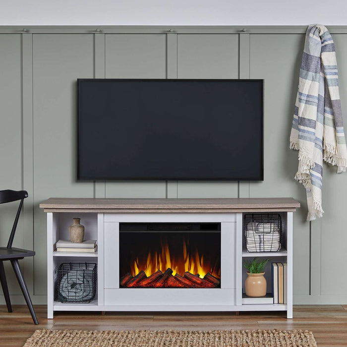 Real Flame Tramore white electric fireplace TV stand styled in a sage green living room with wall-mounted TV above, decorative baskets and books on shelves, jute rug