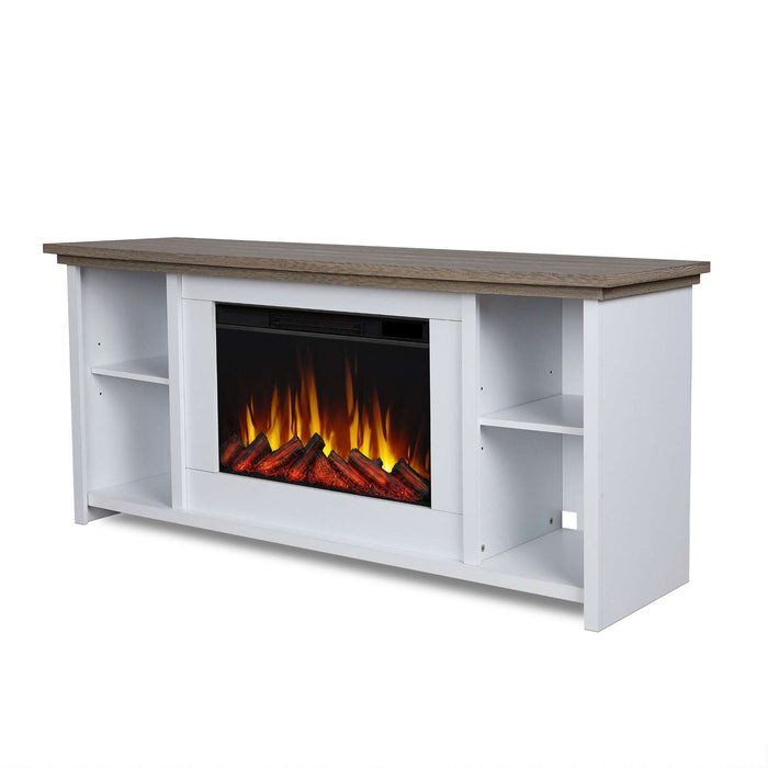 Three-quarter angled view of the Real Flame Tramore electric fireplace TV stand in white with driftwood gray top, open shelving, and glowing orange flame firebox insert