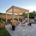 10x10 Urban Escape pergola kit installed over stone patio with outdoor furniture and grill