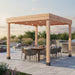 Outdoor Living Today Urban Escape Pergola Kit with string lights over an outdoor dining set beside a pool and outdoor kitchen at dusk