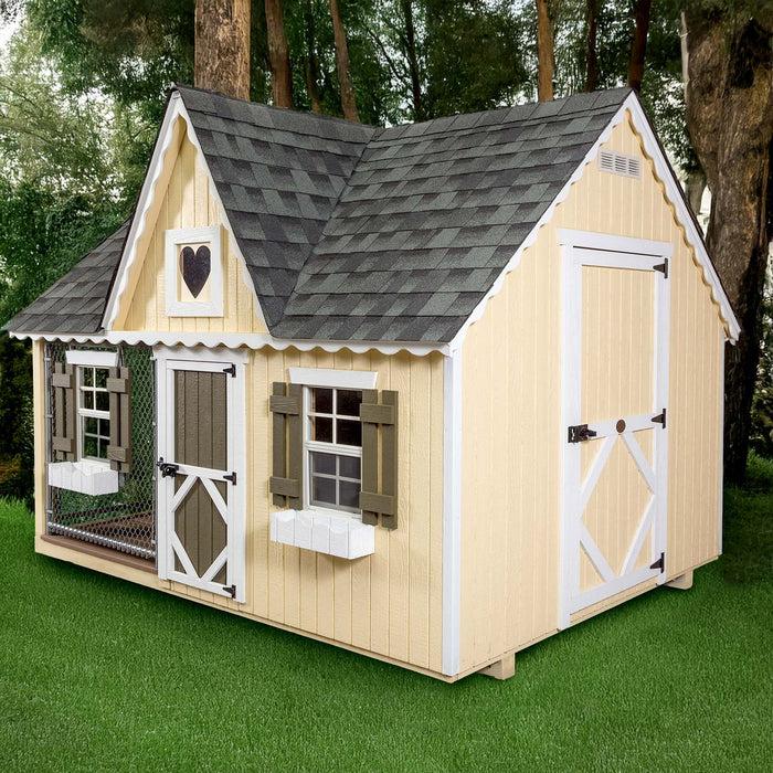 Front view of Little Cottage Co. Victorian Cozy Kennel with yellow siding, heart gable, and green shutters on grassy lawn