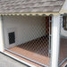 Open chain-link side view of Victorian Cozy Kennel with wooden floor and small access door